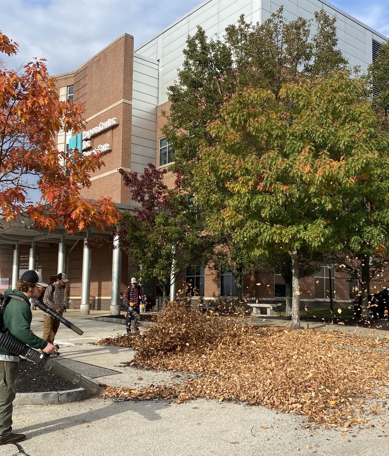 Kyle Poirier Landscaping LLC crew doing fall cleanup at commercial building